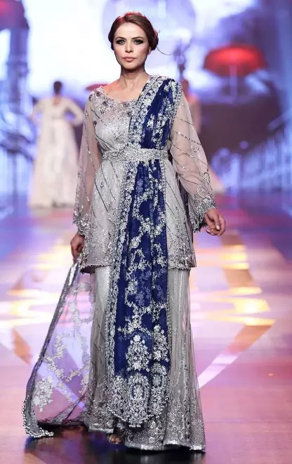 Silver Grey Bridal Dress. The Grey short shirt has been adorned with an embellished neckline and border on the hemline. The royal blue bridal dupatta makes it the perfect bridal dress for nikah.