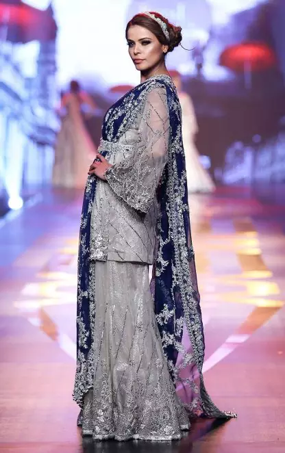 Silver Grey Bridal Dress. The Grey short shirt has been adorned with an embellished neckline and border on the hemline. The royal blue bridal dupatta.