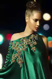 Bottle Green Formal Cape features beautiful embroidery on the bodice and sleeves. Concealed back zip closure. The dress comes with cigarette pants and a Matching dupatta.