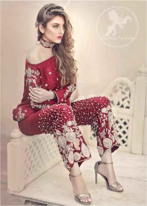 Deep red pure raw silk forms a chic short shirt, its sleeves a canvas of full embroidery, while an embellished