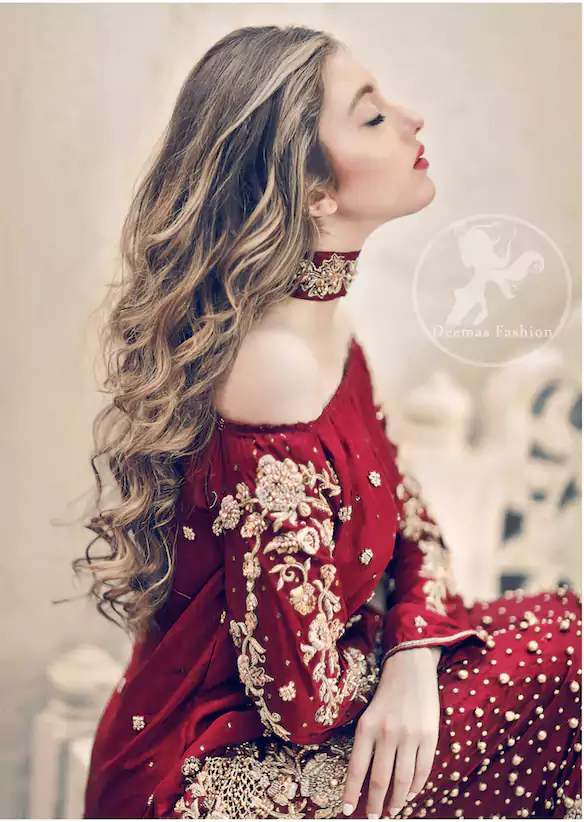 The accompanying trousers are equally striking, with deep red embellished motifs implemented at their bottom for a harmonious flow. A delicate net dupatta, scattered with a shimmering stone spray, adds an ethereal layer to the ensemble. This party wear outfit is a testament to meticulous handcraft, featuring rich embroidery in kora, dabka, and sequins. Crafted from the highest quality imported fabric, it promises to make a bold and unforgettable statement. Every detail, from the precise stitching to the radiant color, is designed for a night of glamour and sophistication.