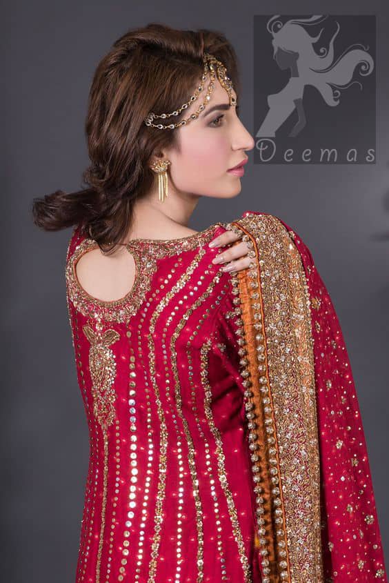 Crimson A-line slits shirt adorned with beautiful neckline, stripes and hemline. Matching dupatta having embellished border on four sides, sequence and small motifs spray all over it. Lehenga in Crimson and Copper having embellished Gott like gharara (below the knee), stripes and small motifs spray. Embellishment in light and dark antique shades.