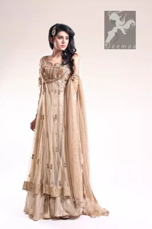 Fawn Blouse adorned with antique gold and brown embellishment. Fawn pure crinkle chiffon gown center slits border has been adorned with light embellishment border and follows small motifs and sequence spray all over it. Pure crinkle chiffon sharara and dupatta has sequence spray all over it.
