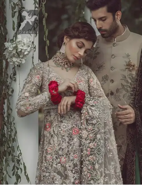 Light grayish fawn net maxi and dupatta. Bridal maxi adorned with silver, light golden, antique shades and colorful thread embellishment.