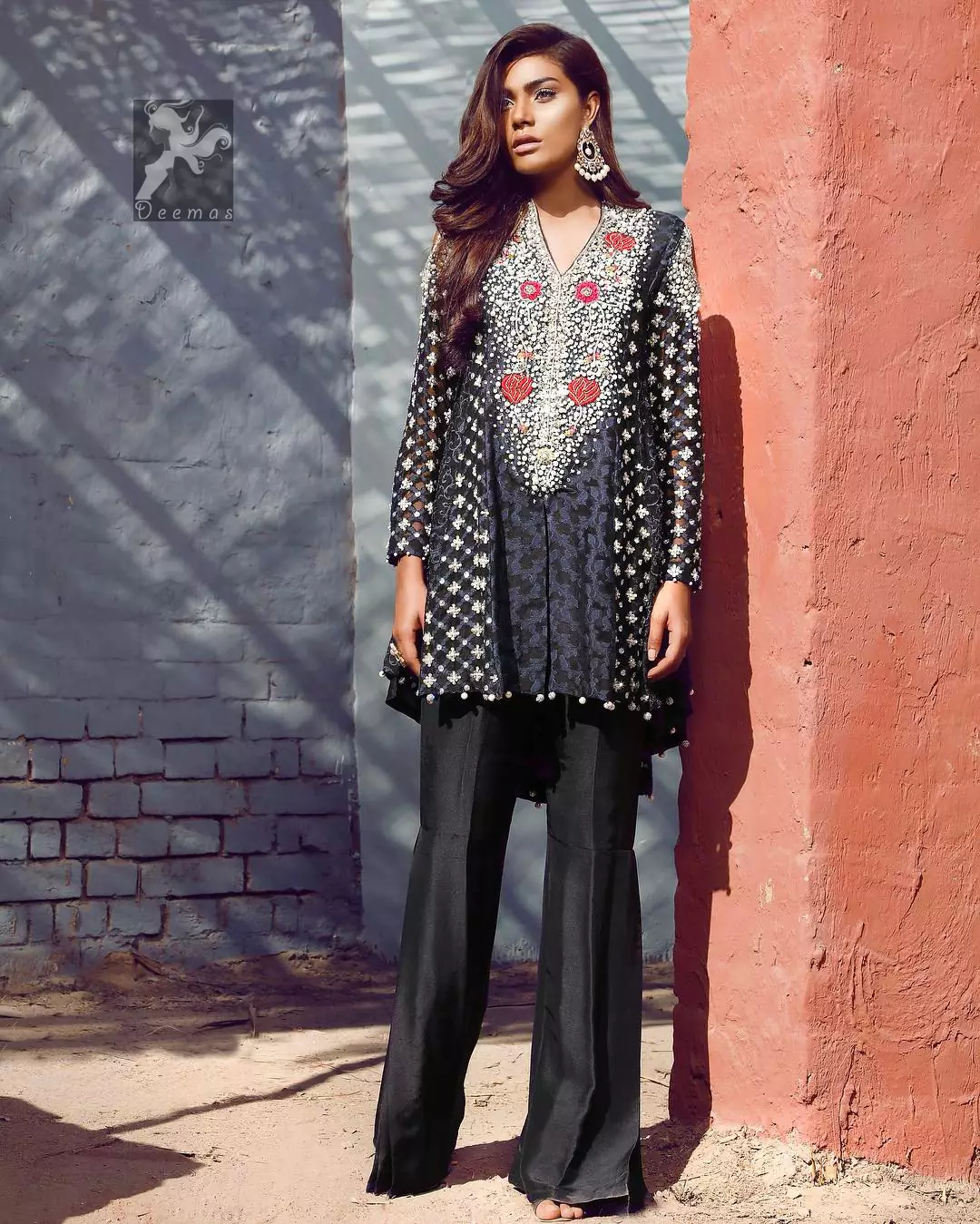 Black peplum made with pure banarsi jamawar chiffon. Peplum has multiple panels of different banarsi patterns. The white and silver embellishment on the neckline, side panels, and sleeves. Pure raw silk sharara pants.