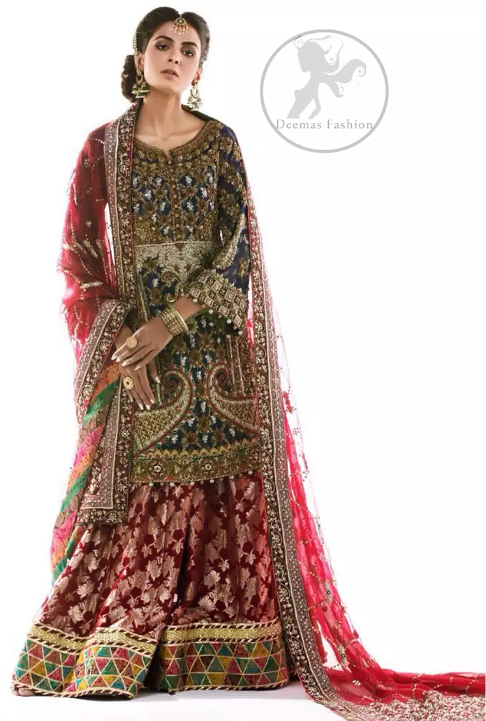 This outfit is featuring different shaded kora, dabka, tilla, sequins and pearls.This dress is beautifully sculptured with floral embroidery. It is fully embellished shirt. It is artistically coordinated with brocade sharara adorned with beautiful border on hemline. It comes with brown derby net dupatta havinng embroidered border on four sides and criss cross sequins spray all over it.
