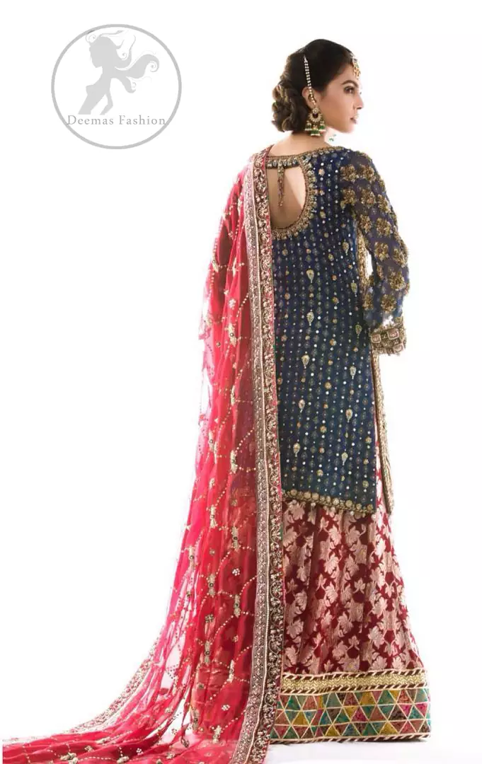 This outfit is featuring different shaded kora, dabka, tilla, sequins and pearls.This dress is beautifully sculptured with floral embroidery. It is fully embellished shirt. It is artistically coordinated with brocade sharara adorned with beautiful border on hemline. It comes with brown derby net dupatta havinng embroidered border on four sides and criss cross sequins spray all over it.
