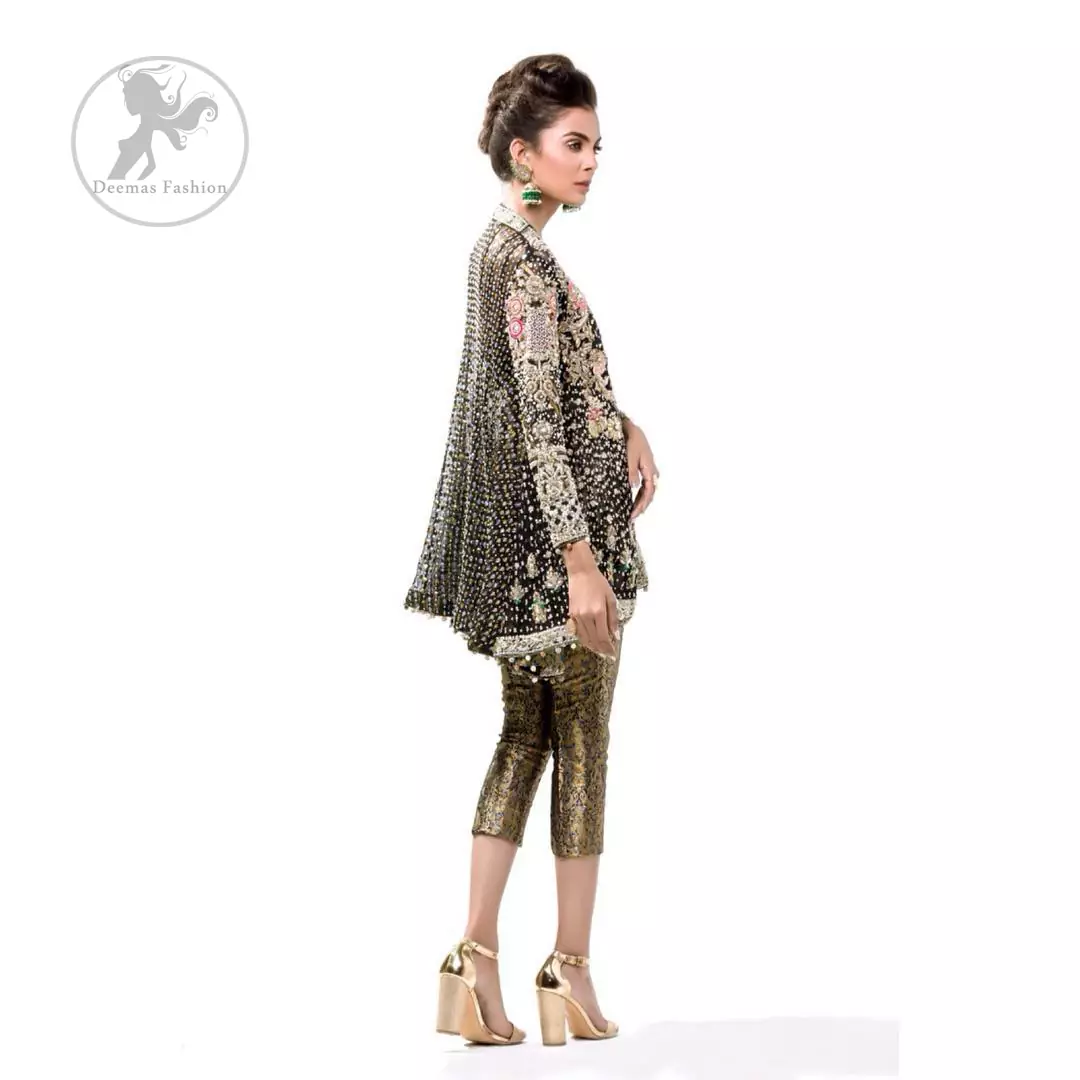 This classic forest black peplum style shirt meticulously highlighted with dull golden kora, dabka ,tilla, sequins and pearls. It has silhouettes  and cutwork on sleeves.It is adorned with V-Shaped neckline. Its full sleeves are fully embroidered. This shirt is decorated with small and large sized floral motifs. It comes with brocade capri pants and beautifully decorated with forest black dupatta having sprinkled sequins all over it.
