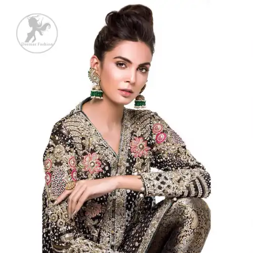This classic forest black peplum style shirt is meticulously highlighted with dull golden kora, dabka,tilla, sequins and pearls.