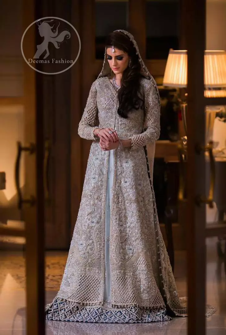 This outfit is beautifully sculptured with floral embroidery. It is adorned with intricate cutwork borders embellished with silver kora, dabka, pearls and sequins work all over. Inner is embellished with blue embroidered border. It is artistically coordinated with heavy embellished chiffon/net dupatta with blue appliqued border on sides. It comes with light gray brocade churidar pajama.
