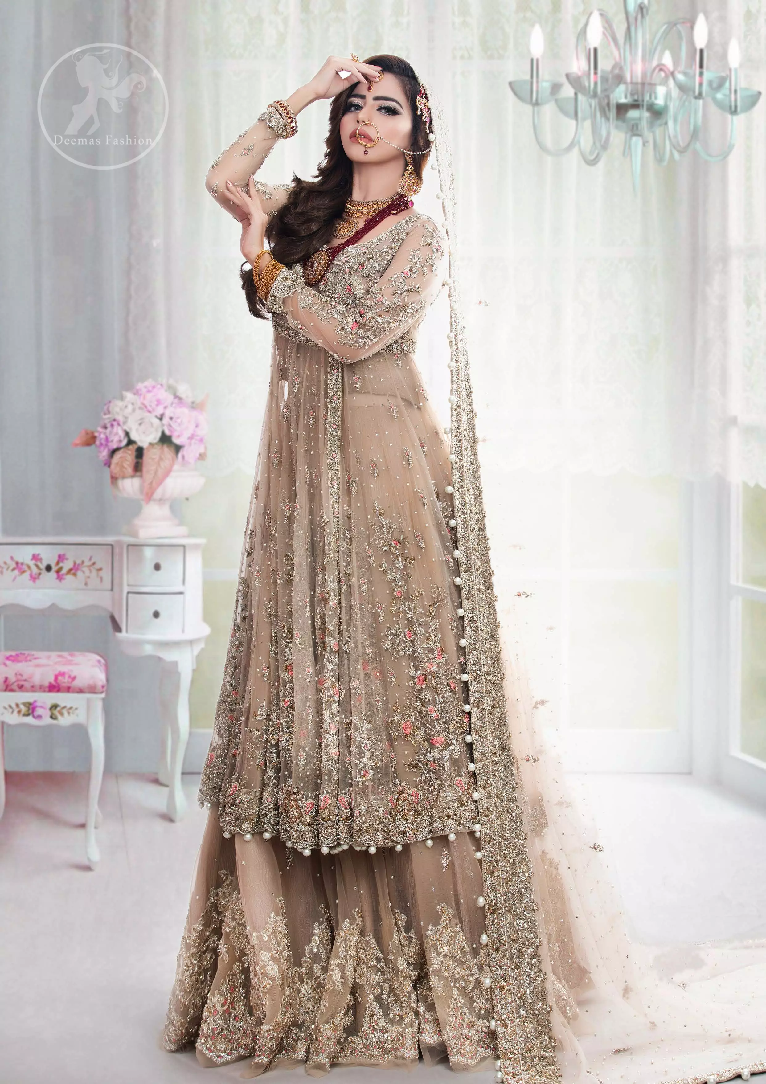 This outfit is meticulously featuring antique shades of kora, dabka, tilla, sequins and pearls. This dress is beautifully sculptured with floral embroidery. Angrakha is decorated with tassels which adds to the look. It is adorned with scalloped border. It comes with heavy embellished lehengha which has been adorned with large border on hemline. It is artistically coordinated with embellished dupatta.
