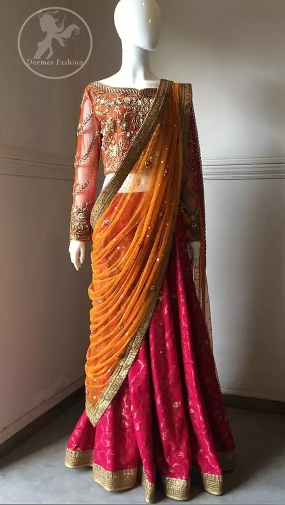 This dress is beautifully sculptured with floral embroidery. It is adorned with intricate detailing embellishment with antique   gold  kora dabka, tilla, kundan and swarovski. The blouse  has full length sleeves decorated with floral motifs. It is coordinated with hot pink banarsi lenhengha finished with golden gota lace at the bottom. It is enhanced with floral motifs.
The outfit is beautifully coordinated with orange pallu style dupatta embellished with golden Gotta lace on all sides.
