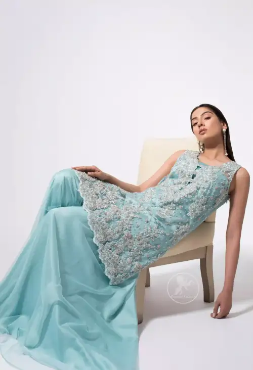 This classic shadow green shirt, meticulously highlighted with silver kora, dabka, tilla, sequins and pearls. This dress is adorned with