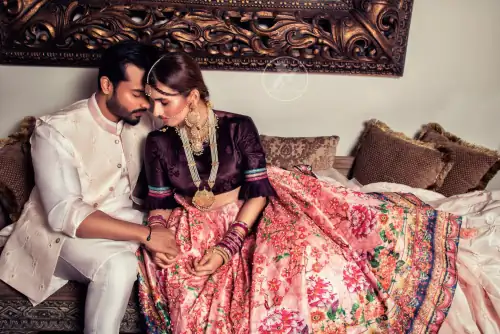 This outfit is a timeless beauty. Dark purple self-printed blouse is decorated with applique. The raw silk classic lehenga is