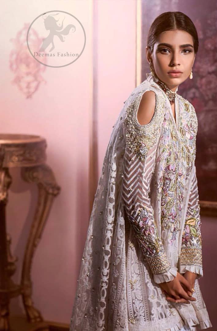 Reflecting exuberant color play in this ethereal piece meticulously highlighted with Swarovski, pearl and silver gold kora dabka. The neckline is fully embellished with multiple color thread embroidery and floral motifs. Cold shoulder sleeves also decorated with silver gold kora dabka , tilla and thread embroidery. It comes with matching chiffon dupatta and pajama.