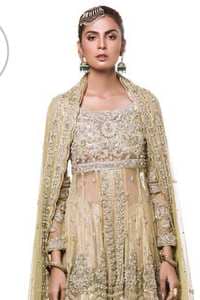 This dress is beautifully sculptured with floral embroidery. It is meticulously highlighted with antique shaded kora, dabka, tilla, sequins and pearls. It is embellished with beautiful tassels which adds to the look. It is artistically paired up with gharara which comprises of floral thread colourful motifs. It comes with chiffon dupatta which has four sided embellished borders and sprinkled with small sized sequins motifs all over it.