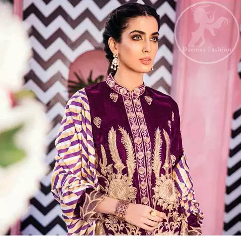 This outfit is a timeless beauty. It is embellished with golden kora, dabka, tilla and kundan. This shirt is fully decorated with floral motifs all over it. Round collar neckline ornamented with small sized floral patterns. It is further enhanced with golden floral thread embroidery. It comes with magenta shalwar which has small sized sprinkled floral motifs all over. This Outfit is beautifully coordinated with multiple colored lining dupatta.