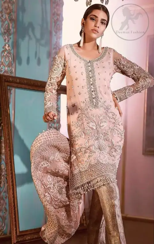 This outfit is decorated with silver kora, dabka, tilla, sequins and pearls. This dress is embellished with floral embroidery and