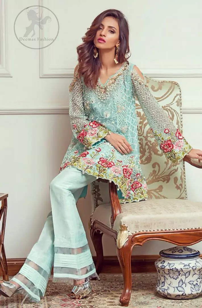 This outstanding self embroidered short frock embellished with floral thread embroidery. It is allured with resham kora dabka tilla and pearls. Sleeves are decorated with cold shoulders design and floral embroidery. Scalloped hemline ornamented with tassels. It is beautifully paired up with matching bell bottom trouser. It comes with light blue dupatta sprinkled with sequins all over it.
