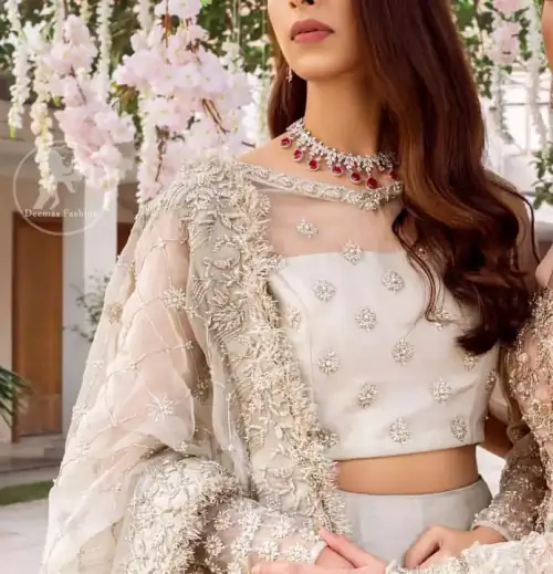 This super stunning skirt is made of rich floral embroidery which is further enhanced with kora dabka work. Blouse is