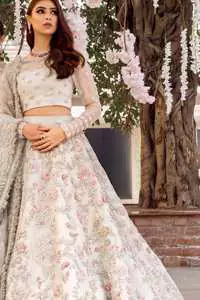 This super stunning skirt is made of rich floral embroidery which is further enhanced with kora dabka work. Blouse is meticulously embellished from neckline and sprinkled floral motifs on ground. It is paired up with ivory dupatta embellishment on sides which looks so breathtaking elaborate it with crisscross lines.