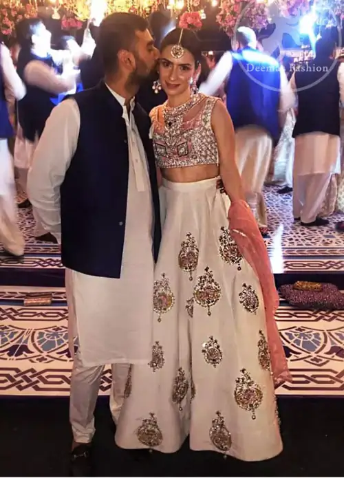 The blouse is beautifully embellished with cutwork embroidery enhanced with silver gold kora dabka, kundan and sequins work. It is