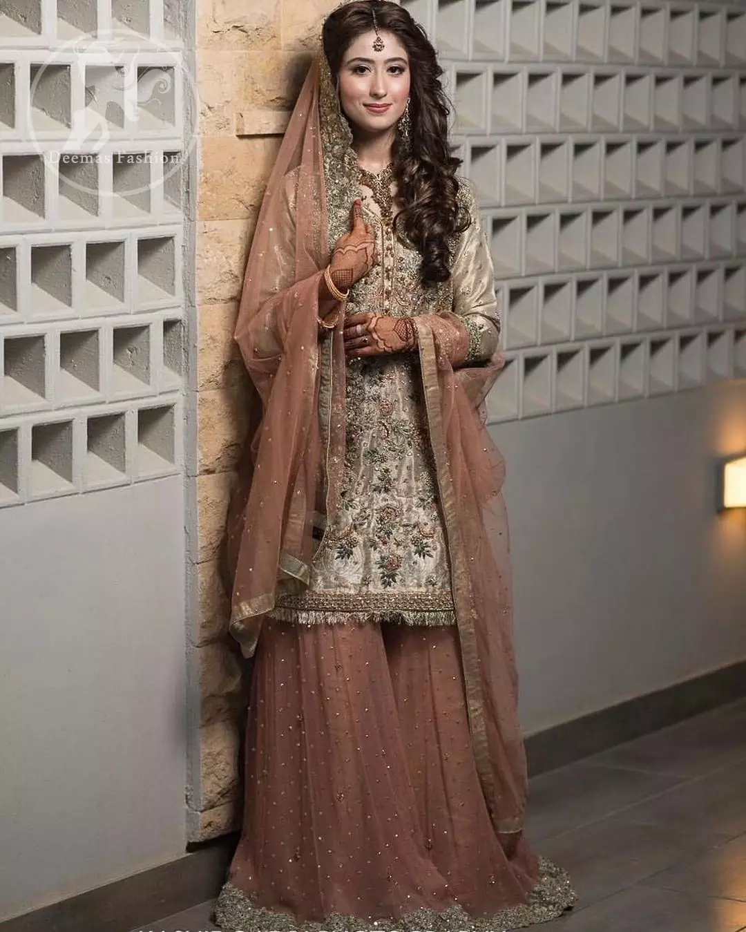Exude elegance and class in this tissue shirt finessed with beautiful embellishment. The shirt is delicately ornamented with multiple colored zardozi work. Daman of the shirt is enhanced with lace. It comprises with antique brass sharara adorned with thick embellished borders and sprinkled sequins. It coordinated with antique brass dupatta with embellished borders on length of dupatta.