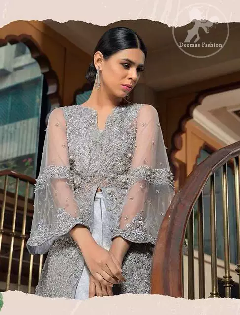 This dress is timeless beauty. Light gray, dress with heavy embellishment with swarovski crystals and silver work in sequins, kundan and kora dabka. The back trail is allured with intricate embroidered patterns and floral motifs. It is finished with light gray sharara.