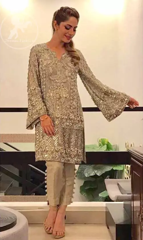 This dress is beautifully sculptured with floral embroidery. It is allured with kora, dabka, tilla, sequins and pearls. Bell shaped sleeves adds to the look. It comes with pants which is allured with buttons. It is coordinated with chiffon dupatta, sprinkled with sequins all over it.
