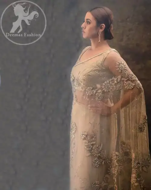 This dress is beautifully sculptured with floral embroidery. Pallu is highlighted with kora, dabka, tilla, sequins and pearls. It comes