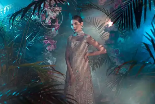 This dress is decorated with floral embroidery. It is highlighted with kora, dabka, tilla, sequins and pearls. Back trail frock