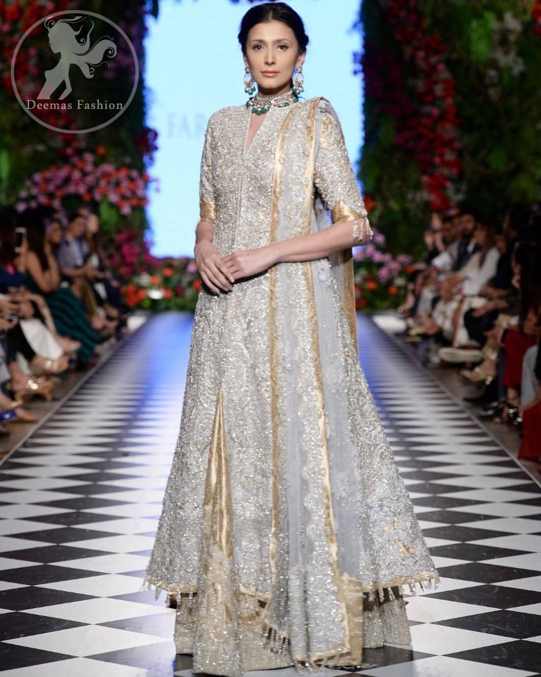 This dress is adorned with floral embroidery, highlighted with kora, dabka, tilla, sequins and pearls. It is allured with intricate embroidered motifs and delicate tassels. It is decorated with brocade applique. It comes with embellished lehengha. It is artistically coordinated with chiffon dupatta which is allured with four sided border.