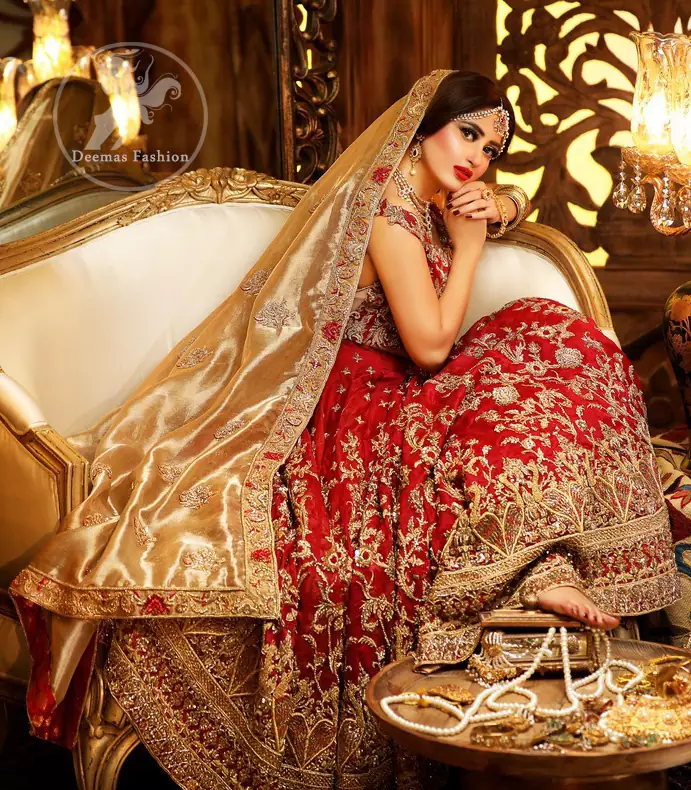 Reflecting royalty and the majestic beauty of statuesque shape and silhouette this bridal dress is perfect for your special day. Feel glamorous in this floor length maxi with fascinating embellishment around the neckline with golden kora dabka, pearls and sequins. It is further enhanced with floral motifs and heavy embroidered bottom. The hemline is decorated with heart shape motifs all around the bottom of maxi. It comprises with brocade pajama and golden dupatta having four sided embroidered borders and sprinkled small motifs on ground.

