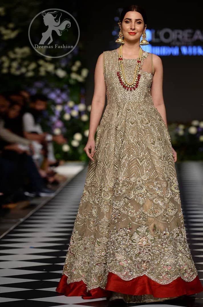 Delicately crafted and personifying chic elegance with an element of grandiose. This dress is beautifully sculptured with floral embroidery, adorned with cutwork borders embellished with dull gold and silver kora, dabka, pearl and sequins work all over. Moreover it is enhanced with different styles multiple colored embroidered motifs and finished with marron applique. This outfit comes with brocade pajama. It is coordinated with tissue dupatta which is sprinkled with sequins all over it. 
