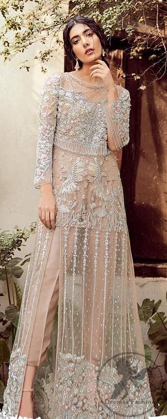 Exude elegance and class in this shirt finessed with beautiful embellished daaman. This dress is beautifully decorated with heavy embroidery. It is highlighted with silver kora, dabka, tilla, sequins and pearls. Bodice is ornamented with heavy embellishment and addition of tassels to complete the look. It comes with matching capri. It is coordinated with chiffon dupatta which is sprinkled with sequins all over it.