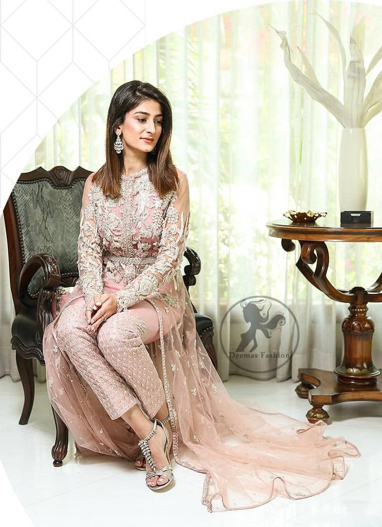 This dress is beautifully decorated with heavy embroidery. It is highlighted with dull golden kora, dabka, tilla, sequins and pearls. Fish lehengha is fully embellished.Blouse is scalloped. It comes with beautifull upper gown, sprinkled with sequins all over it. It is coordinated with chiffon dupatta which is sprinkled with sequins all over it.