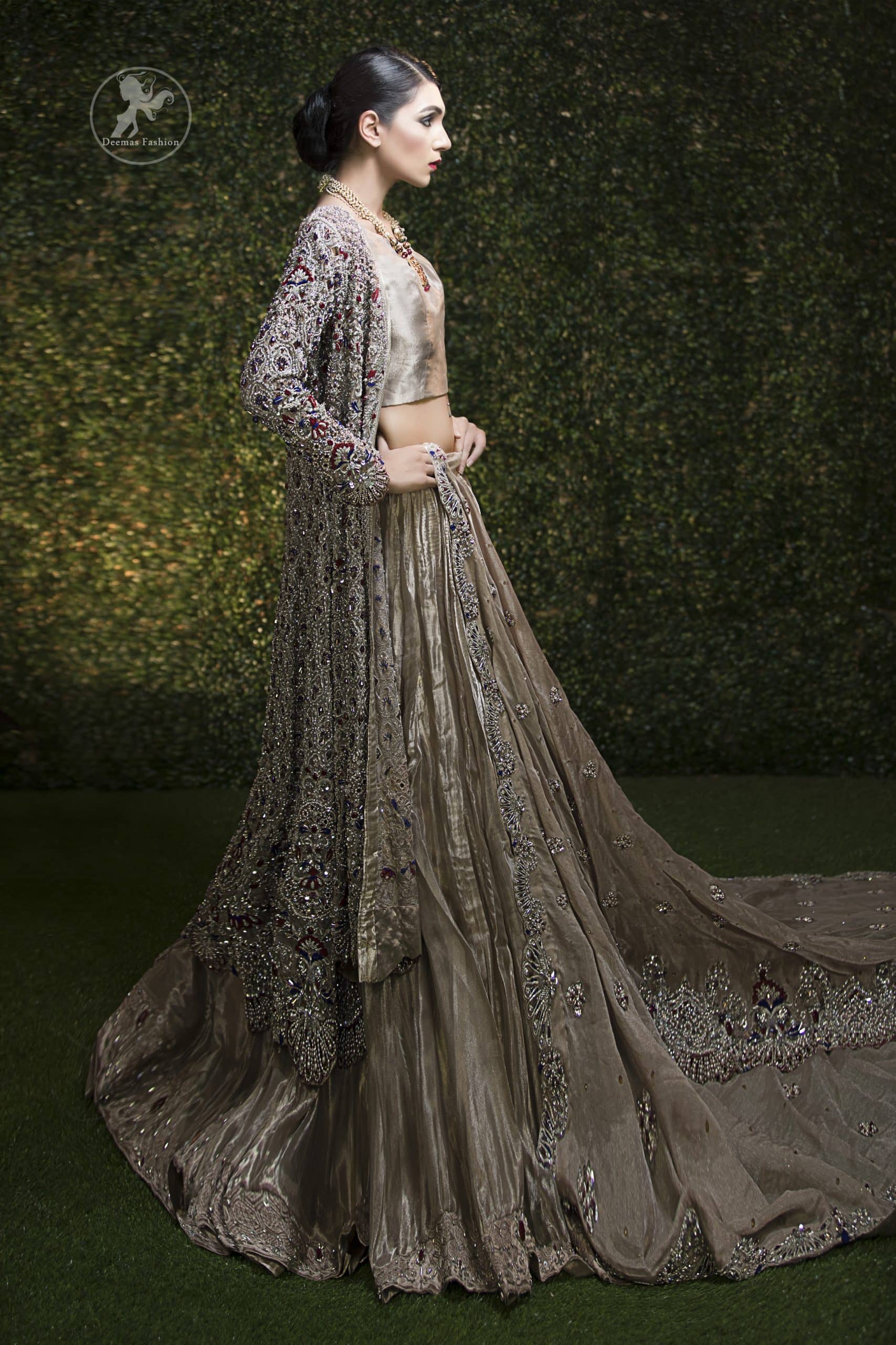 This bridal dress is beautifully decorated with floral embroidery. Gown is allured with floral embroidery and embellished scalloped border. It is adorned with kora, dabka, tilla, sequins, stones and pearls. It comes with an exquisite lehengha with embroidered border to give it a regal look. Dupatta comprises of floral thread embroidery allured with embellished border and floral motifs all over it.