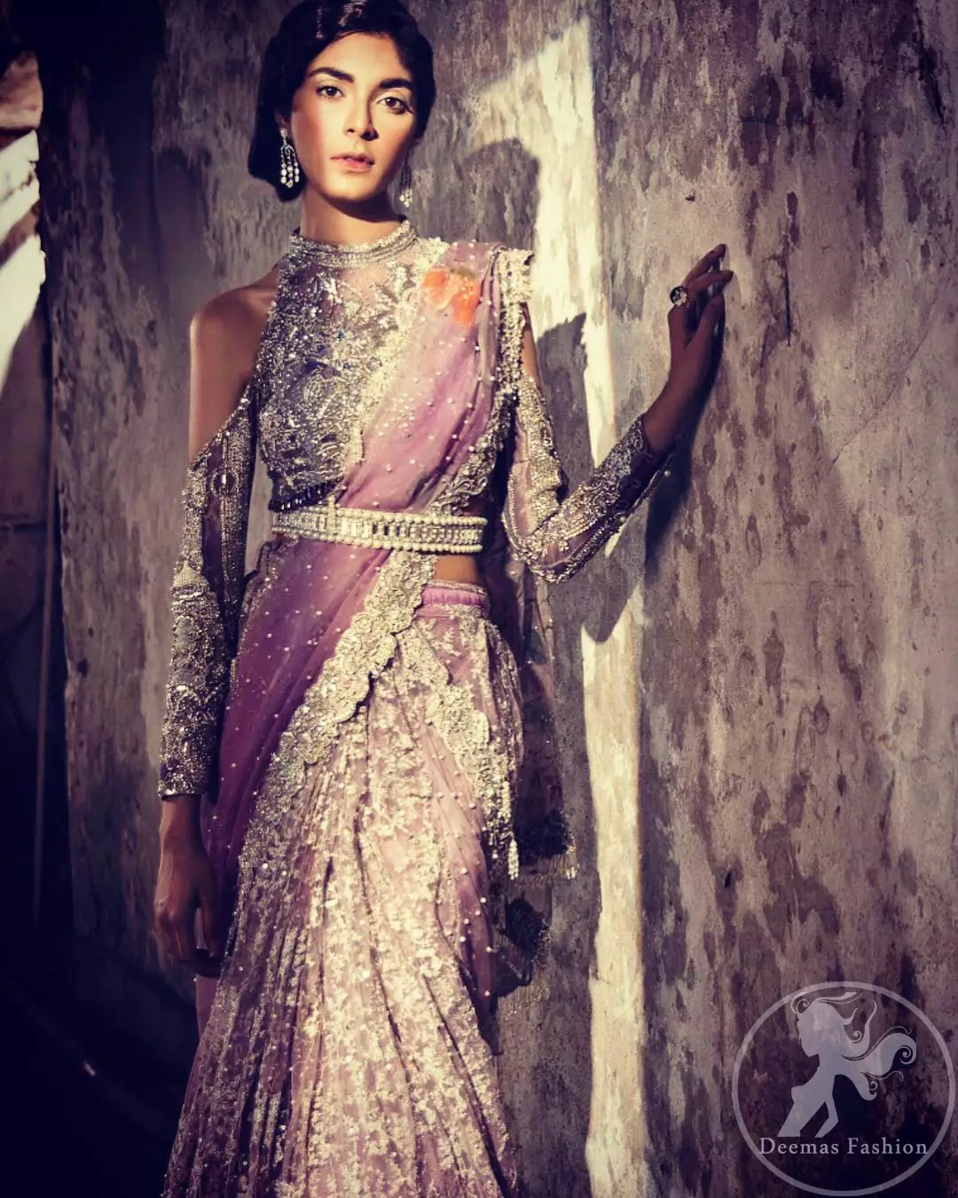 This dress is beautifully sculptured with floral embroidery. It comes with fully embroidered brocade blouse having halter neckline which adds to the look. Pallu is highlighted with kora, dabka, tilla, sequins and pearls. It is allured with scalloped embroidered border. Lehengha is fully embellished.