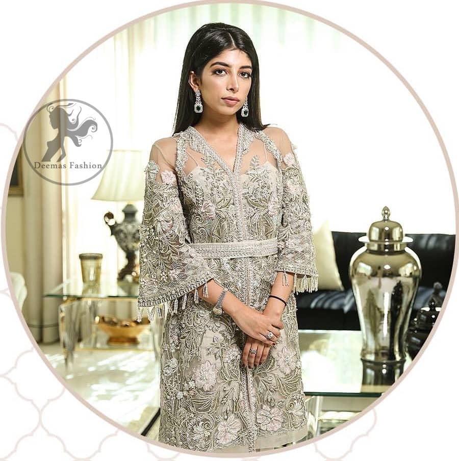 Create a vision of elegance with this front open shirt decorated with intricate floral embroidery detailing and silver kora, dabka and sequins. It is further enhanced with embellished fixed waist belt. Third quarter bell sleeves are adorned with floral embroidery and zardosi work, finishing with tassels at the end. This outfit paired up with raw silk bell bottom. It is coordinated with tissue dupatta which is sprinkled with sequins all over it.