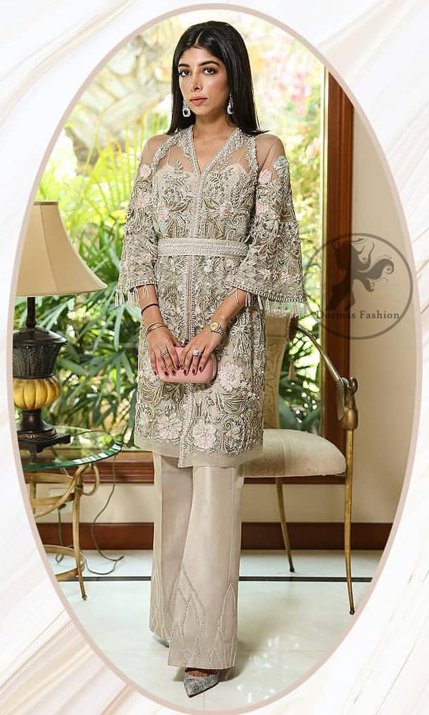 Create a vision of elegance with this front open shirt decorated with intricate floral embroidery detailing and silver kora, dabka and sequins. It is further enhanced with embellished fixed waist belt. Third quarter bell sleeves are adorned with floral embroidery and zardosi work, finishing with tassels at the end. This outfit paired up with raw silk bell bottom. It is coordinated with tissue dupatta which is sprinkled with sequins all over it.