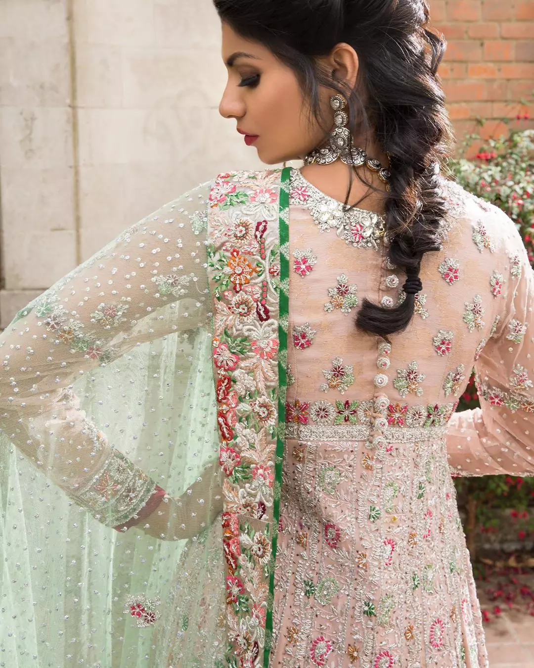 Opt for our ivory multiple-panel anarkali dress with exquisite embellishment on the bodice with pearls, sequins and silver kora, dabka. The daaman comprises of borders highlighted with floral embellished pattern. It is finished with deep blush frilled lehengha which adds to the bling. Dupatta is allured with four sided embellished border and sprinkled with stones all over it.