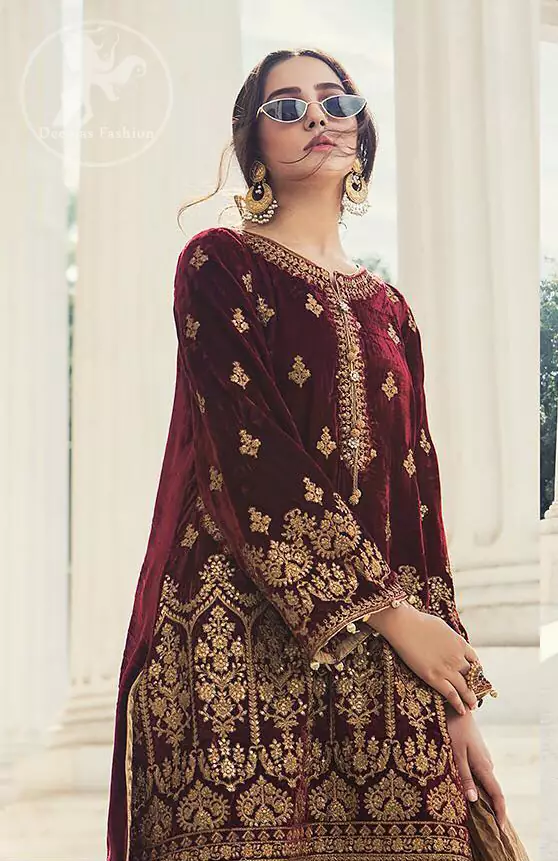 This dress is beautifully decorated with floral embrroidey. Decorated with mesmerizing antique gold kora, dabka and zardozi embellished neckline border and sleeves. Our maroon velvet shirt will add glamour to your style. Delicate tassels adds to the bling. It comes with jamawar shalwar. Dupatta is of tissue fabric.