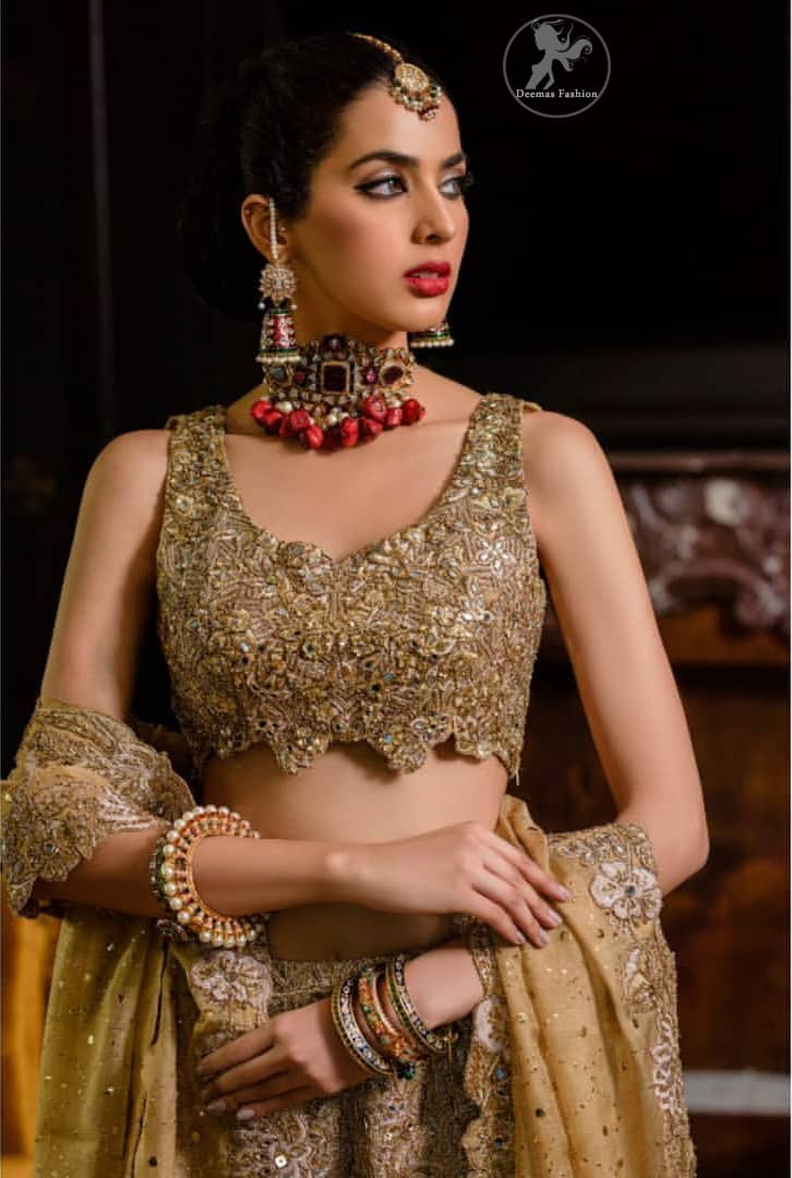This bridal dress is perfect for your special day. Blouse is beautifully decorated with floral embroidery and embellished scalloped border. It is adorned with kora, dabka, tilla, sequins and pearls. It comes with an exquisite lehengha with thick embroidered border to give it a regal look. Dupatta comprises of floral thread embroidery allured with thick embellished border