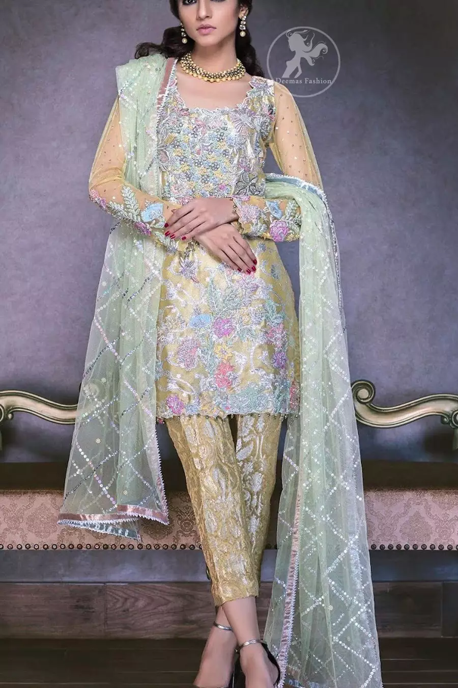 This dress is beautifully decorated with heavy embroidery. It is highlighted with dull golden kora, dabka, tilla, sequins and pearls. Fish lehengha is fully embellished.Blouse is scalloped. It comes with beautifull upper gown, sprinkled with sequins all over it. It is coordinated with chiffon dupatta which is sprinkled with sequins all over it.This dress is beautifully decorated with heavy embroidery. It is highlighted with dull golden kora, dabka, tilla, sequins and pearls. Fish lehengha is fully embellished.Blouse is scalloped. It comes with beautifull upper gown, sprinkled with sequins all over it. It is coordinated with chiffon dupatta which is sprinkled with sequins all over it.
