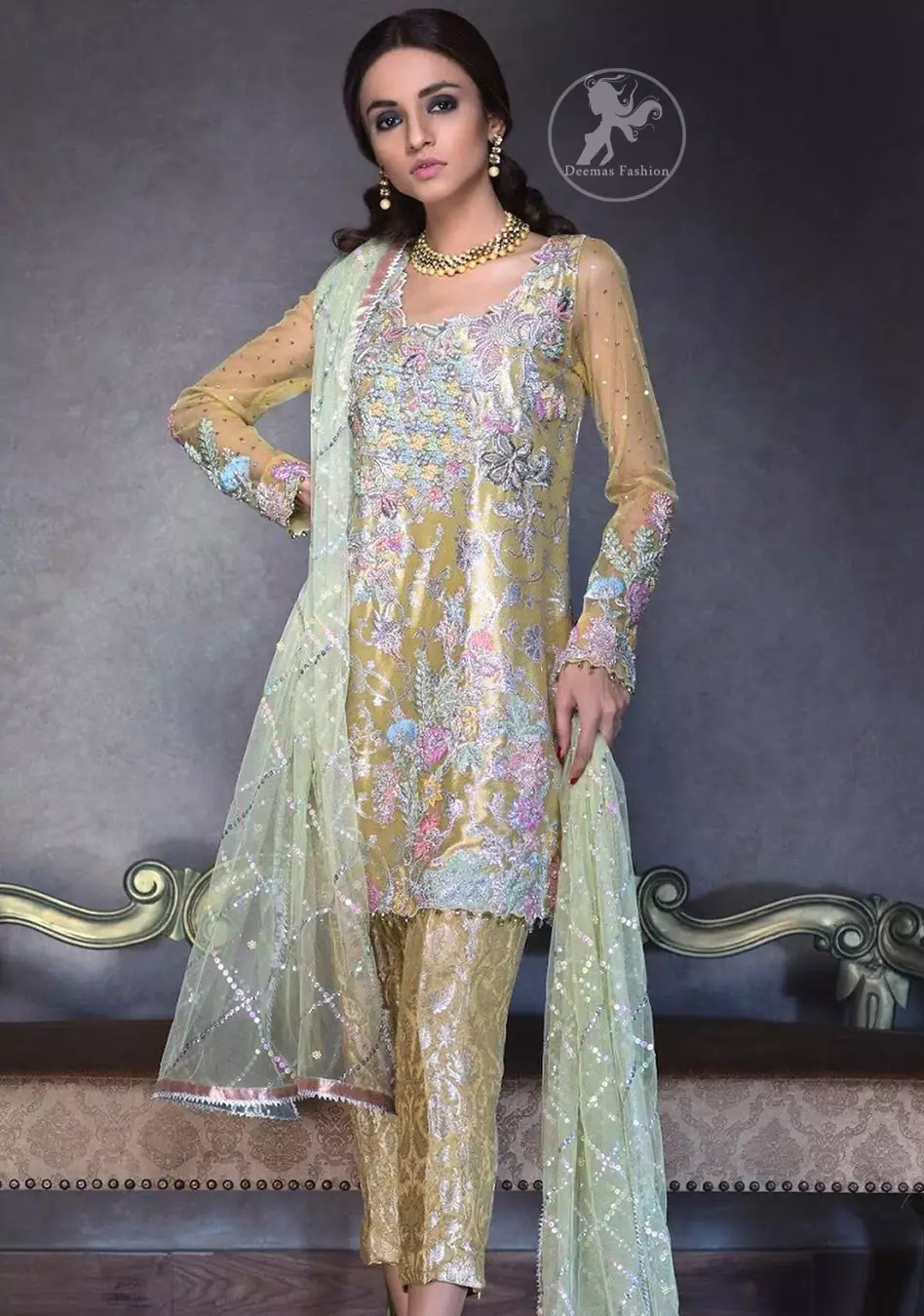 This super stunning  shirt is made of rich floral embroidery which is further enhanced with colorful gota work.  It is highlighted with gota work, sequins and pearls. The detailed scalloped border gives a perfect ending to this shirt. It comes with indian khaki trouser. It is coordinated with chiffon dupatta which is sprinkled with sequins all over it.
