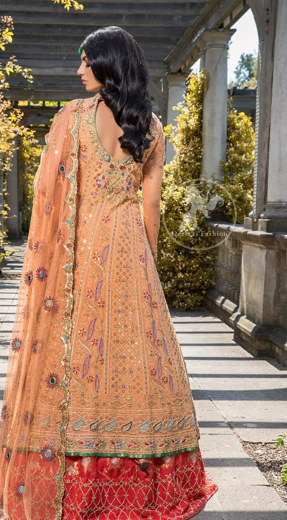Go for this trendy dress and capture the attention in this persian red inner gold sand gown with kora, dabka and kundan embroidery. The gown is decorated with different size floral motifs and multiple color thread embroidery. Inner is enhanced with geometric pattern details on the bottom. Paired up with brocade straight trousers. It is coordinated with chiffon dupatta which is sprinkled with sequins and small floral motifs all over it. Further it has scalloped borders on all four sides embellished with zardosi work.