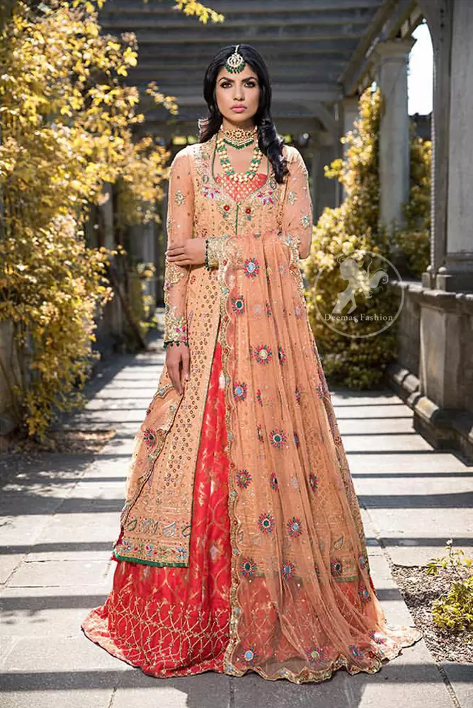 Go for this trendy dress and capture the attention in this persian red inner gold sand gown with kora, dabka and kundan embroidery. The gown is decorated with different size floral motifs and multiple color thread embroidery. Inner is enhanced with geometric pattern details on the bottom. Paired up with brocade straight trousers. It is coordinated with chiffon dupatta which is sprinkled with sequins and small floral motifs all over it. Further it has scalloped borders on all four sides embellished with zardosi work.