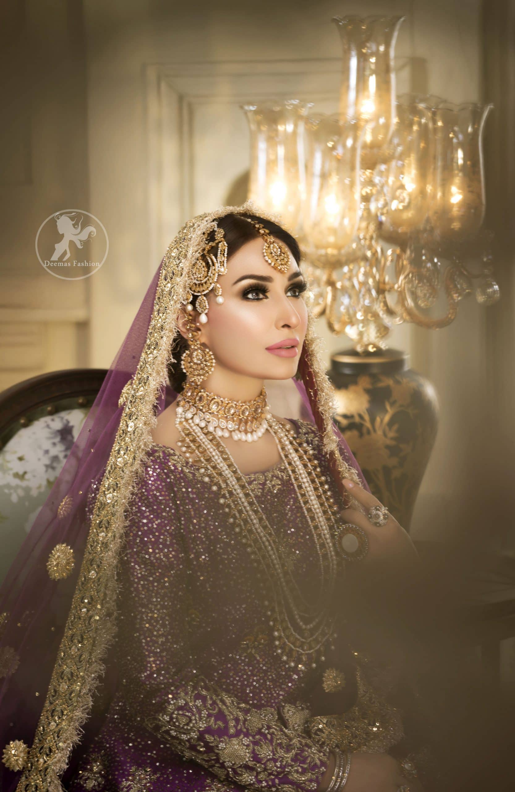 Reflecting royalty and the majestic beauty of statuesque shape and silhouette this bridal dress is perfect for your special day. This dress is beautifully decorated with heavy embroidery. It is highlighted with golden kora, dabka, tilla, sequins and pearls. The short shirt is decorated from neckline and scalloped hemline is decorated with zardosi work. Lehenga is enhanced with floral patterns all over with golden embellishment. It is coordinated with chiffon dupatta which is sprinkled with small floral motifs all over.