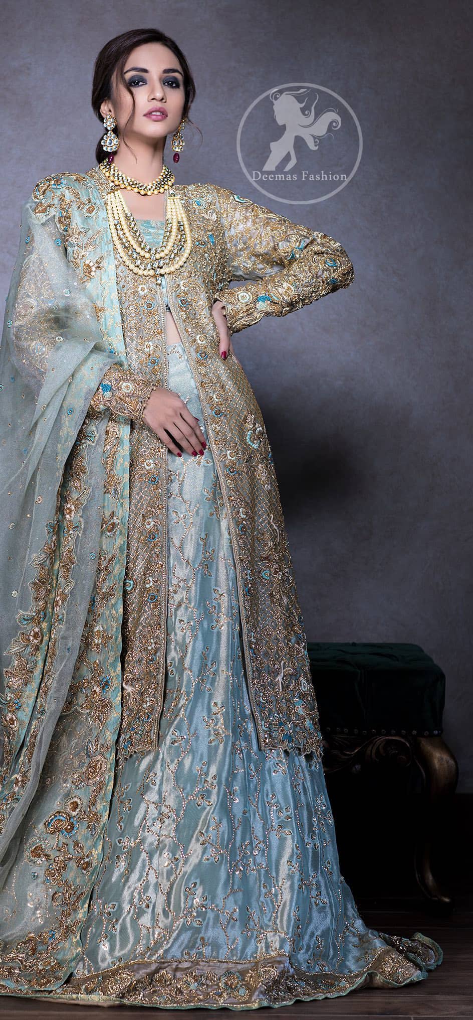 This regal regent gray outfit is an immensely captivating traditional piece, enhancing the art of classical heritage showcasing the craftsmanship of kora, dabka & mukesh detailed with pearls; artistically embellished to give a beautiful rhythm to the outfit. Gown is heavily embellished with antique zardosi work and floral thread embroidery. It comes with embellished lehenga enhanced with embroidered applique on the bottom. It comes with organza dupatta with embellished scalloped border at all ends.
