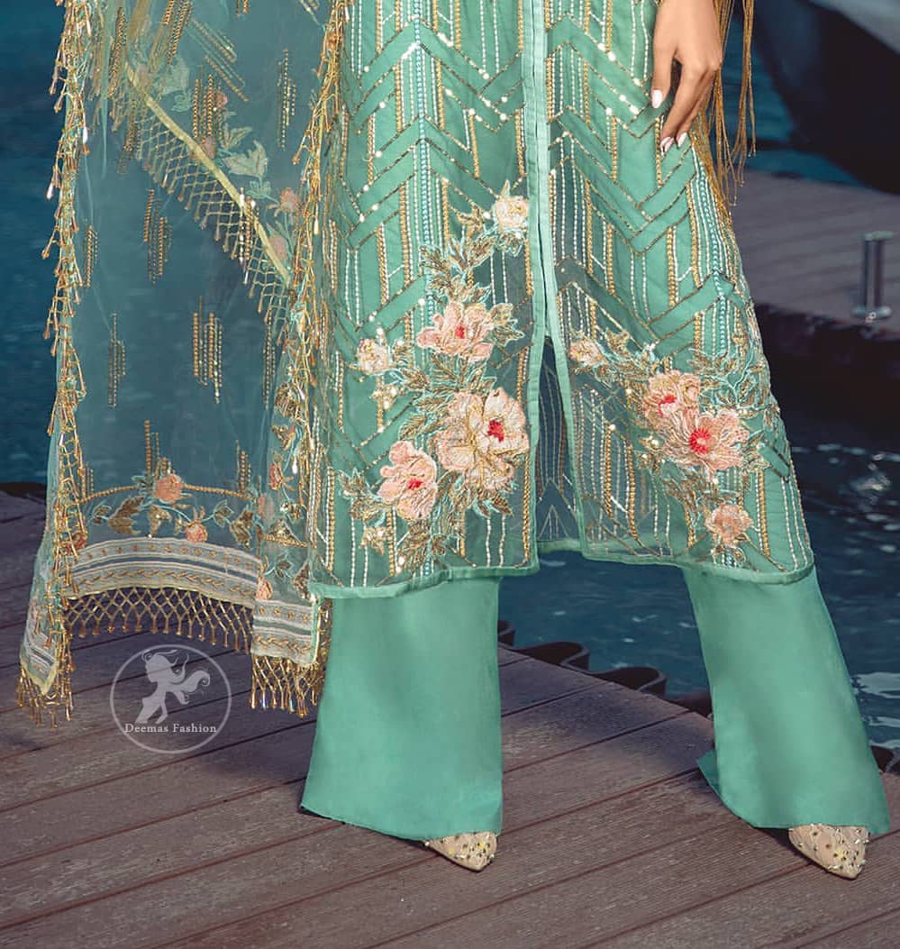 A must have creation for day to evening wear. Reflecting exuberant color play in this ethereal piece meticulously highlighted with swarovski, pearl, silver kora and dabka. It is also decorated with multiple color thread embroidery and golden tassels. It comes with full embroidered bell sleeves. This outfit is coordinated with raw silk bell bottom. The outfit comprises with tissue dupatta which is sprinkled with sequins on the ground.